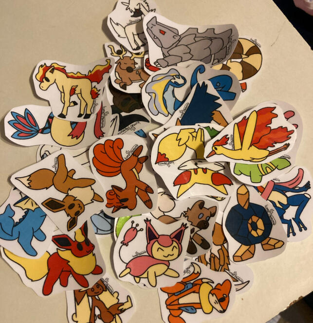 A pile of Pokemon stickers, all of the same artstyle