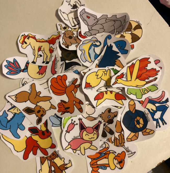 A pile of Pokemon stickers, all of the same artstyle